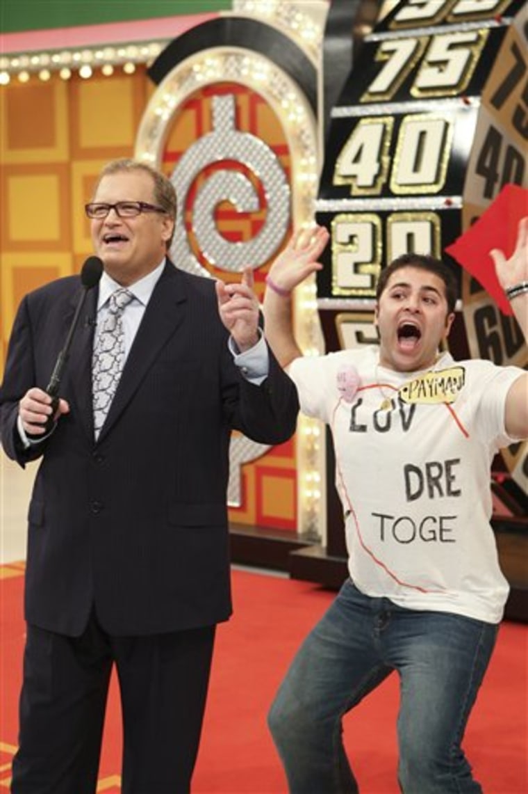In this publicity image released by CBS, host Drew Carey, left,stands with contestant Payman Farrokhgar on stage during "The Price is Right," in Los Angeles. 
